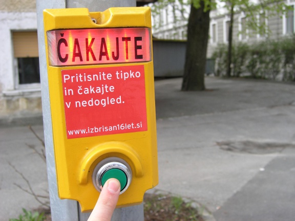 The traffic lights buttons for pedestrians with the sticker saying Press the button and wait forever as part of the Izbrisan16let.si (TheErased16years) project by Poper Studio, set at various locations around the city of Ljubljana, 2008