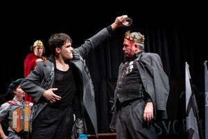 Actors Dane Jemc (in the back), Irena Kožuh (in the back), Gregor Gartner, and Matej Čujovič in Ivo Brešan's play <i>The Stage Play of Hamlet in the Village of Mrdusa Donja</i>. Produced by <!--LINK'" 0:914-->, the play was awarded the Matiček award for the best overall performance at the <!--LINK'" 0:915--> in 2023. Author: Matej Maček