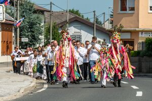The three callers, in regional language called “pozvačini”, inviting people to the festival and leading performing groups to the main venue, 23 July 2023, photo by Boštjan Rous.