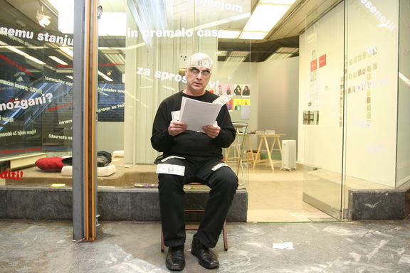 Balint Szombathy, a conceptual artist from Vojvodina, performing Strogo zaupno ('Strictly confidential') in front of the Kapsula Gallery, 2008