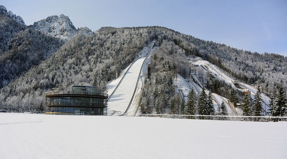 A newly-constructed pavilion opened in 2016 houses also a Planica Museum. In the background, on the left side the 'Gorišek Brothers Ski Flying Hill' built in 1969, while the 'Bloudek Giant' is seen on the right-hand side. The latter was finished in 1934, when it also claimed its first world record.