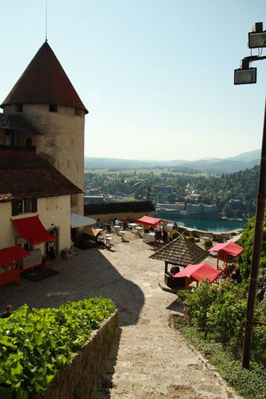 View looking down into the lower courtyard, showing castle outbuildings at Bled Castle, the tower now holds the Castle printing works 2010