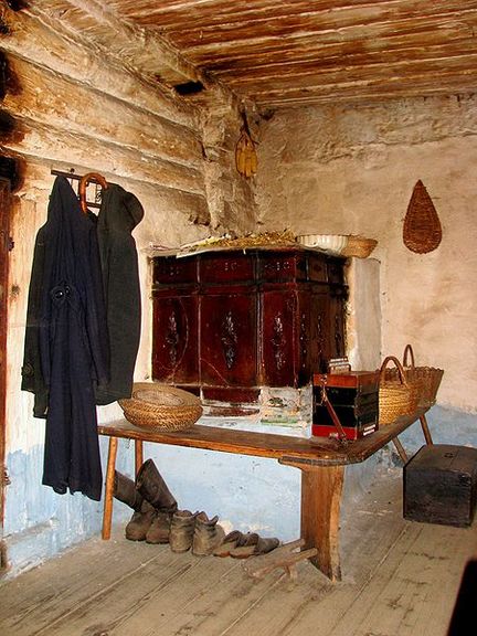 Typical Slovenian tiled stove for heating in Kavčnik Homestead with benches around it for sitting on colder evenings