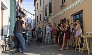 Artist <!--LINK'" 0:251--> performing in front of Salsaverde gallery at the opening of the festival exhibition of the <!--LINK'" 0:252-->, <!--LINK'" 0:253--> 2021.