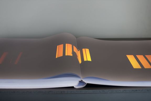 A part of the Warped Space installation representing Slovenian authors at the Prague Quadrennial of Performance Design and Space 2019: a book with projected moving images from the Rear Window dance performance by DUM Association of Artists. Curated by Barbara Novakovič and produced by Muzeum Institute.