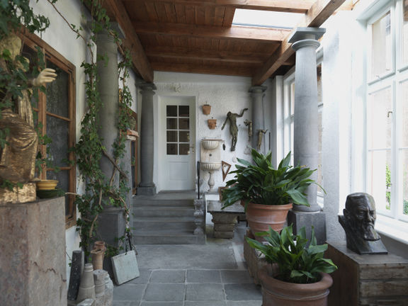 The entry porch in Plečnik House, with the master's collection of sculptures and spolia, 2015.